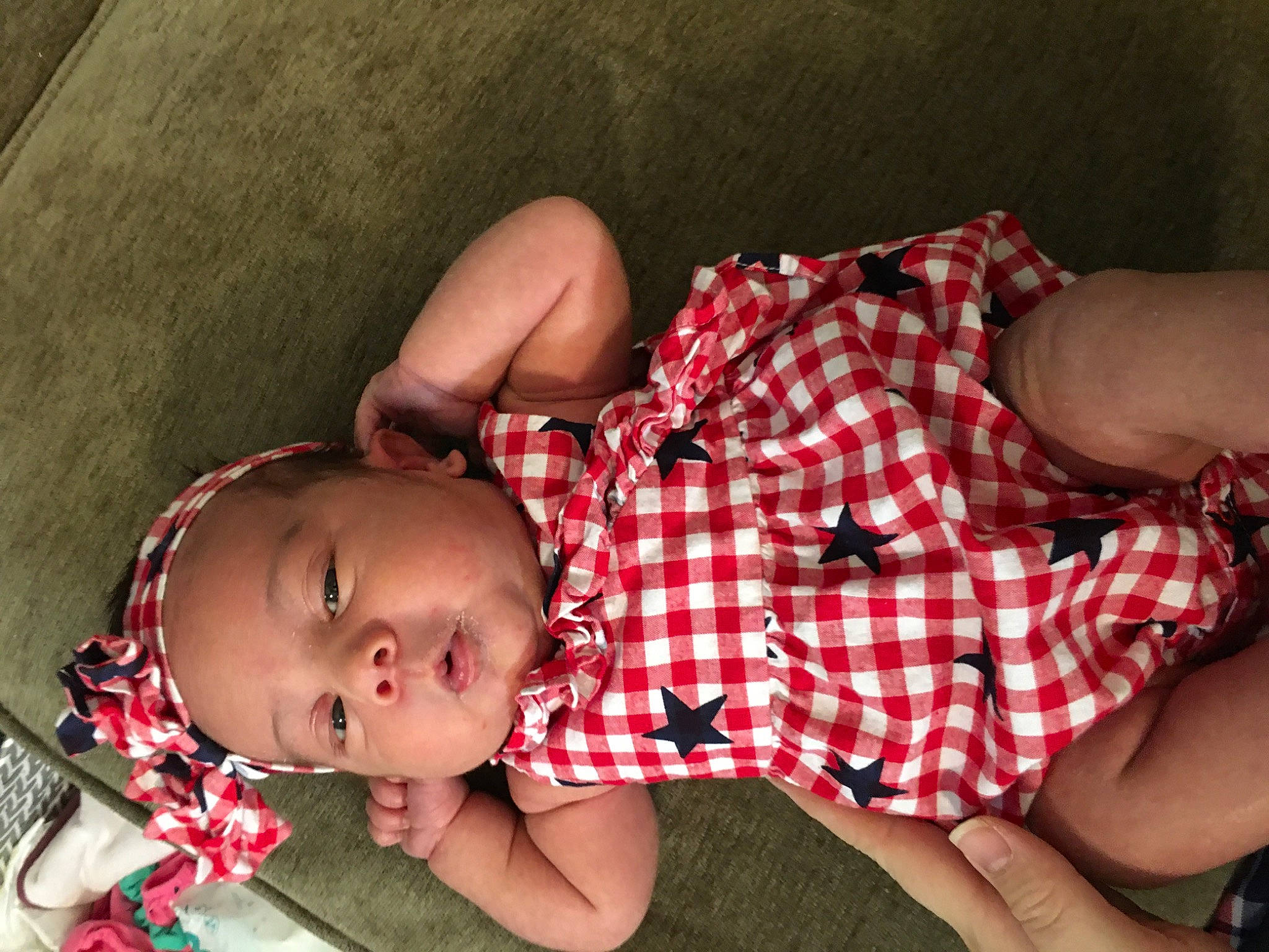 Charlie is registered to the contest to win money with this photo: abdomen, baby, baby_products, baby_toddler_clothing, comfort, finger, flesh, hand, headwear, nail, pattern, person, plaid, sleep, stomach, tartan, trunk