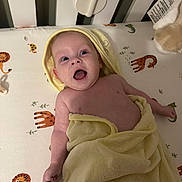Albie joined the competition — help win amazing prizes! baby, infant, towel, crib, bedding, animal_print, giraffe, lion, crocodile, happy, smiling, child, cute, wrapped, laying_down, nursery, indoors, skin, head, arm