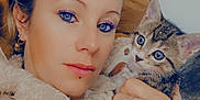 Kiwi participe au concours pour gagner de l'argent avec cette photo : woman, kitten, cat, pet, face, portrait, cozy, jacket, fur, hand, rings, earrings, indoor, resting, cute, animal, cute_pet, closeup, snuggling, blue_eyes