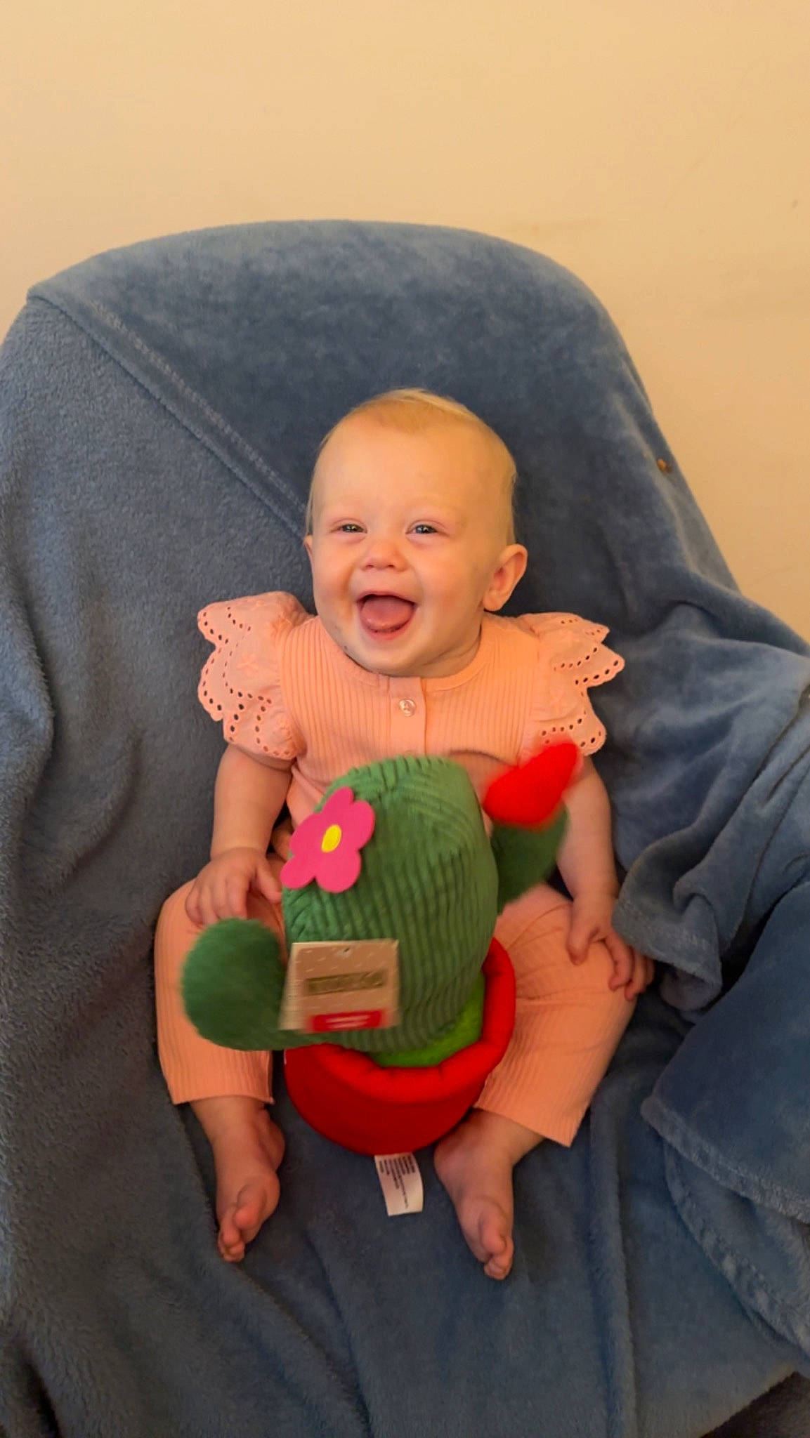 Gabriella is registered to the contest to win money with this photo: baby, baby_products, baby_toddler_clothing, chair, cheek, comfort, eye, finger, fun, gesture, hand, happy, human_body, lap, person, sitting, skin, sleeve, smile, thumb