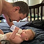 Gunnar joined the competition — help win amazing prizes! baby, bottle, man, indoor, bed, diaper, feeding, person, face, head, blanket, curtains, furniture, closeup, parent, child, care, love, room, soft_light