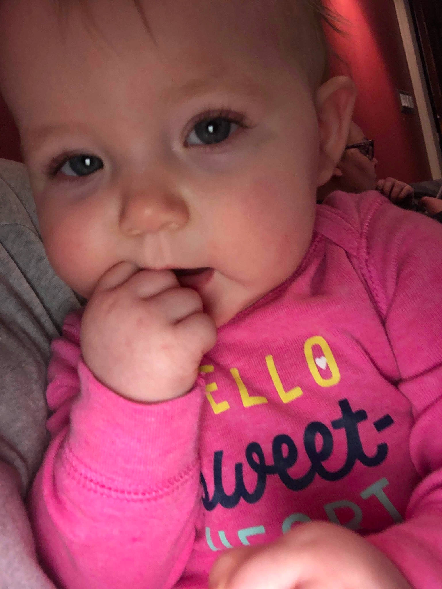 Pamela is registered to the contest to win money with this photo: baby, cheek, child, chin, close_up, eye, face, facial_expression, finger, forehead, hand, head, lip, mouth, nose, person, pink, skin, smile, thumb