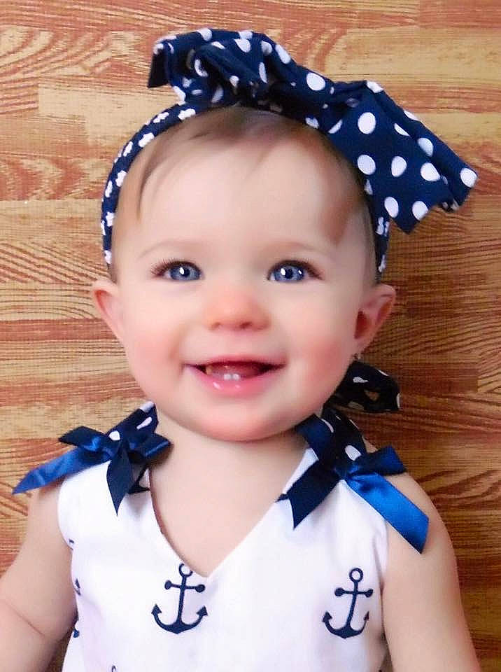 Emaline is registered to the contest to win money with this photo: baby, baby_toddler_clothing, bow_tie, cap, cheek, child, child_model, clothing, costume_accessory, ear, fashion_accessory, hair_accessory, headband, headgear, headpiece, joy, pattern, person, smile, toddler