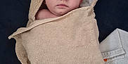 Elyana participe au concours pour gagner de l'argent avec cette photo : baby, towel, hooded_towel, infant, face, eyes, skin, blanket, floor, fabric, soft, wrapped, person, child, indoor, portrait, expression, curious, calm, newborn