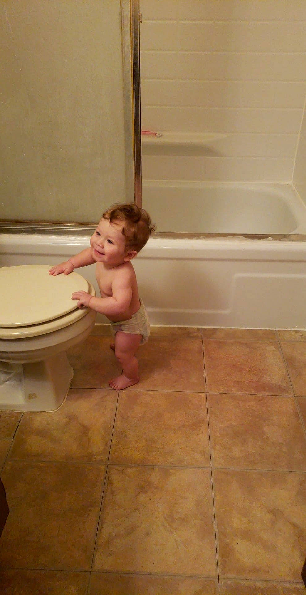 Brexton is registered to the contest to win money with this photo: arm, bathroom, bathtub, floor, flooring, girl, hardwood, joint, joy, laminate_flooring, leg, person, plumbing_fixture, room, shoulder, standing, tile, wood, wood_flooring