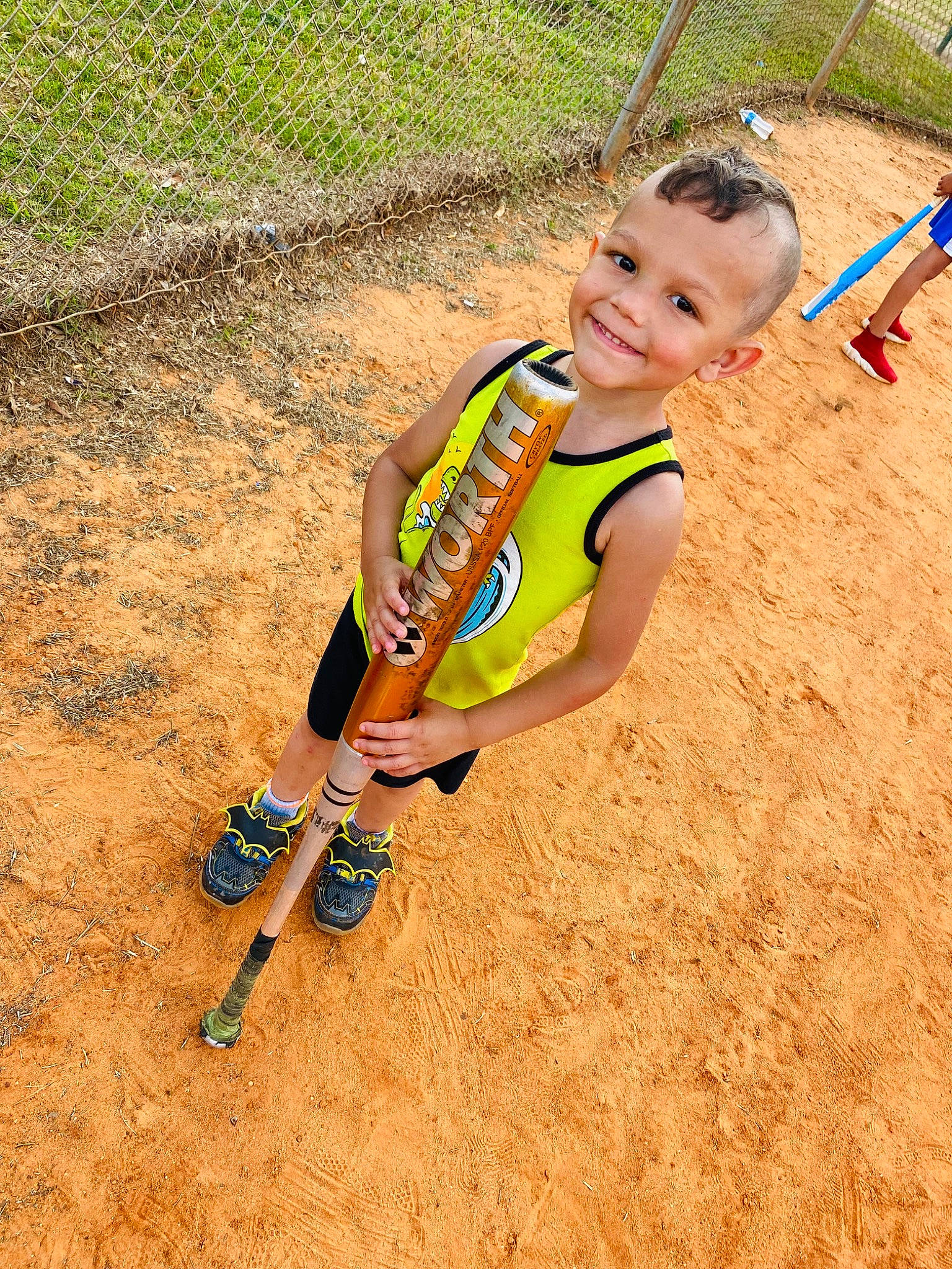 Niko is registered to the contest to win money with this photo: child, competition_event, fun, grass, happy, human_leg, joy, landscape, leisure, people_in_nature, person, player, recreation, sand, shorts, smile, sock, soil, sports, t_shirt