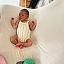Zahra is registered to the contest to win money with this photo: newborn, baby, sleeping, romper, knitted_clothing, white_background, soft_texture, infant, peaceful, lying_down, plush_toy, smartphone, indoors, cute, small_hands, small_feet, relaxed, child, person, cozy