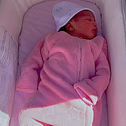 Zahra is registered to the contest to win money with this photo: newborn, baby, sleeping, pink_onesie, white_hat, bassinet, soft_bedding, infant, cozy, peaceful, indoor, child, blanket, cute, portrait, resting, toddler, clothing, sleep, baby_care