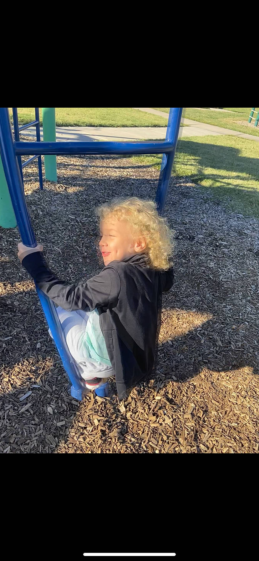 Jesse is registered to the contest to win money with this photo: asphalt, child, city, electric_blue, flash_photography, fun, grass, happy, leisure, outdoor_play_equipment, people_in_nature, person, playground, recreation, shade, sitting, soil, swing, tints_and_shades, toddler