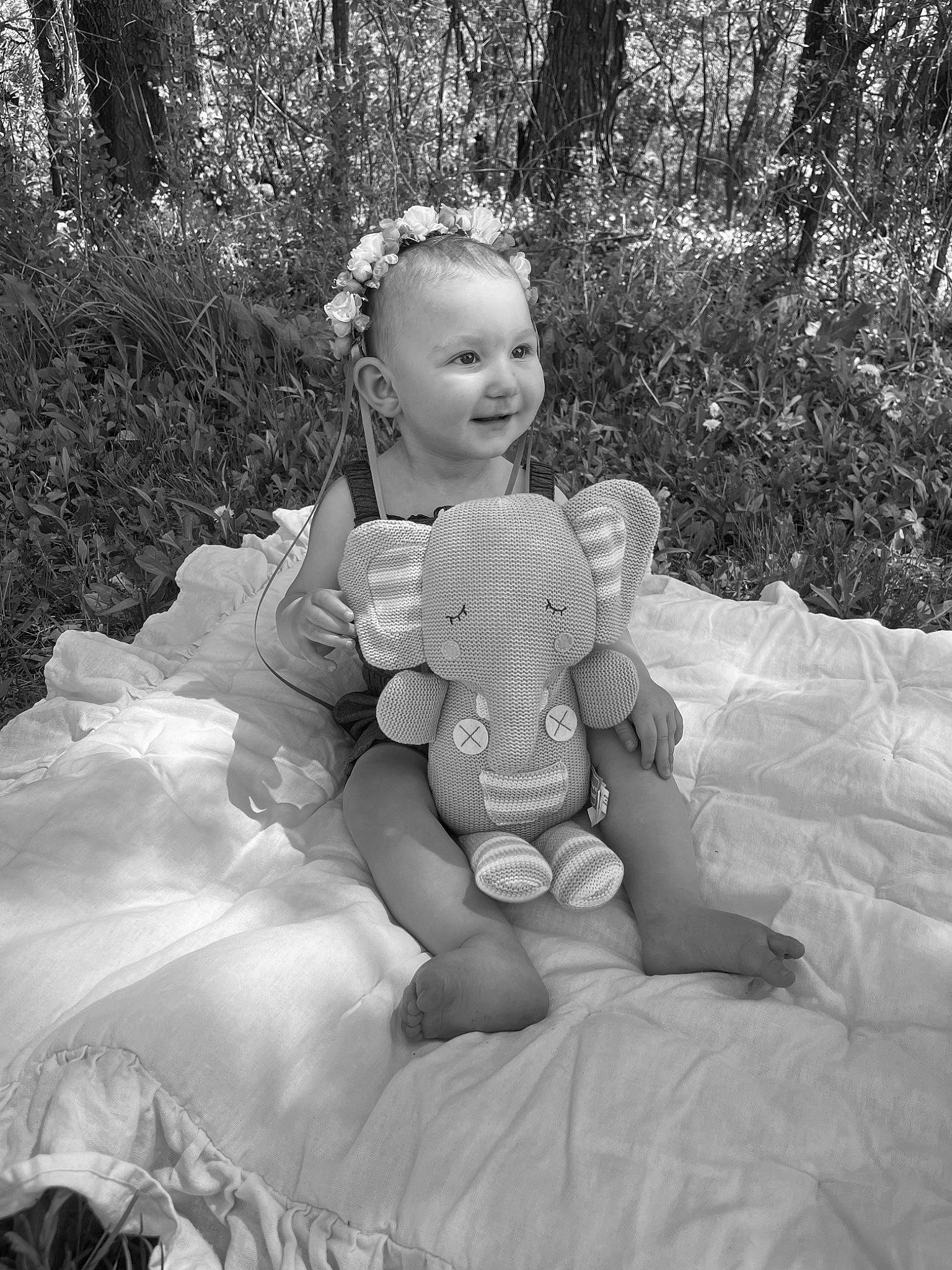 Haley is registered to the contest to win money with this photo: baby, black_and_white, child, flash_photography, fun, gesture, grass, happy, headpiece, leg, monochrome, monochrome_photography, people_in_nature, person, plant, sitting, smile, style, toddler, tree