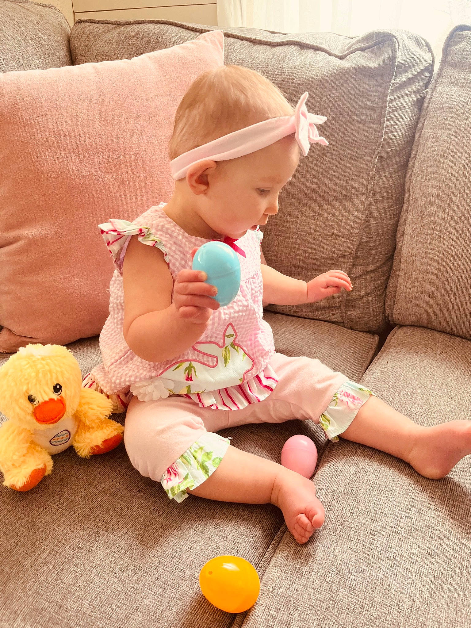 Haley joined the competition — help win amazing prizes! baby, baby_playing_with_toys, baby_toddler_clothing, child, comfort, couch, finger, flooring, foot, happy, human_leg, nail, person, pink, sitting, skin, sleeve, stuffed_toy, thigh, toddler