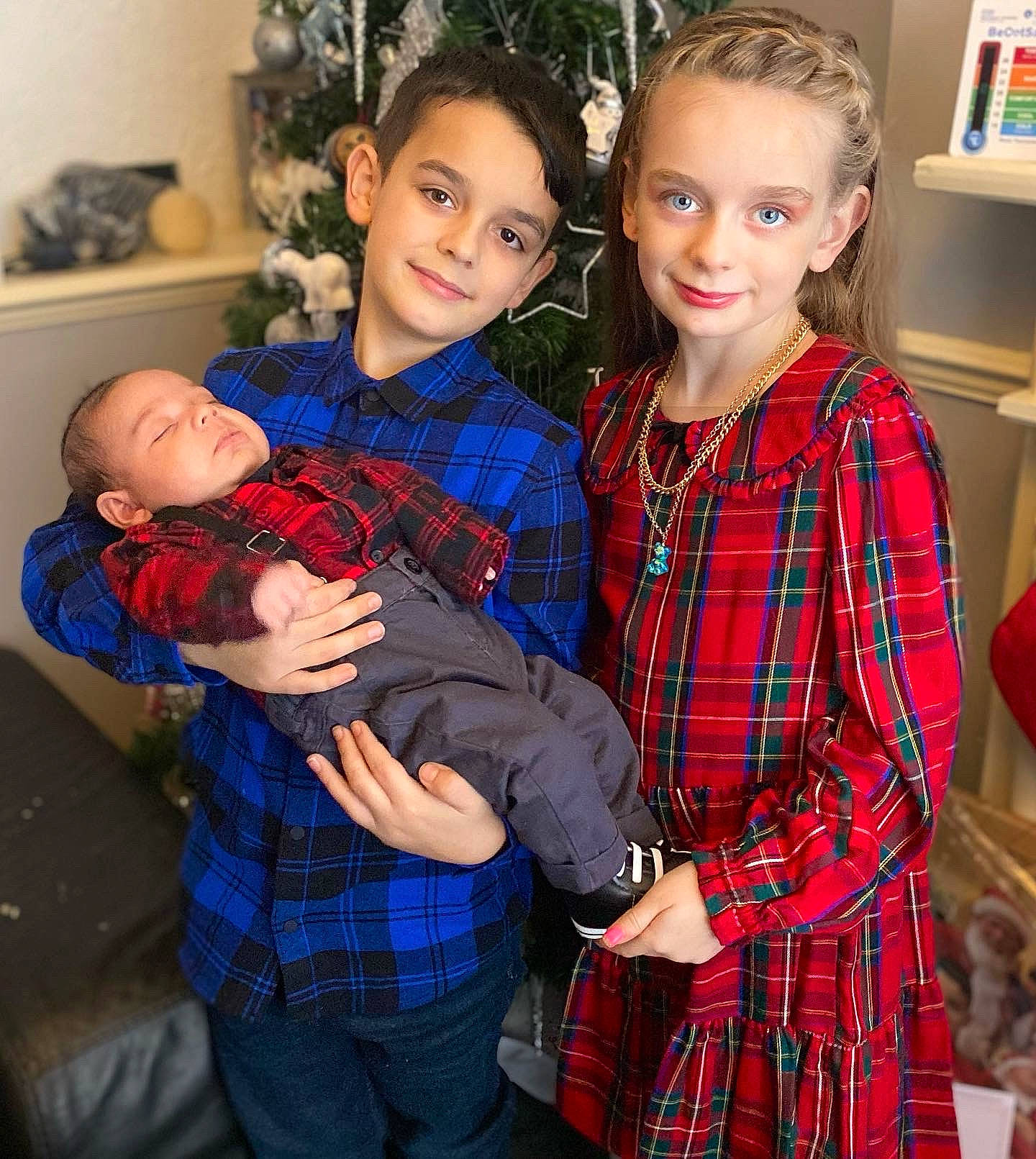 Zak joined the competition — help win amazing prizes! baby_toddler_clothing, belt, blue, child, christmas_tree, dress, event, fun, happy, joy, pattern, person, picture_frame, plaid, red, shelf, sleeve, smile, standing, tartan