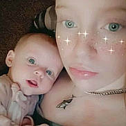 Katelyn joined the competition — help win amazing prizes! baby, infant, child, young_woman, selfie, portrait, close_up, cuddling, indoors, face_filter, sparkles, blue_eyes, freckles, smiling, awake, blanket, necklace, green_clothing, soft_lighting, family
