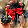 baby, black_dress, red_bow, candle, blackberries, tart, hand, leather_couch, celebration, birthday, smiling, infant, sitting, cute, indoors, tulle_skirt, foot, skin, happy, portrait