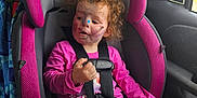 Paityn joined the competition — help win amazing prizes! toddler, child, face_paint, car_seat, curly_hair, pink, gray, seatbelt, car_interior, window, blanket, clothing, hand, legs, sitting, safety, daylight, vehicle, person, curiosity