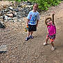 child, boy, girl, outdoor, nature, rocks, creek, trail, trees, greenery, water_bottle, marvel_tshirt, shorts, sandals, playful, smile, pose, sunlight, summer, adventure