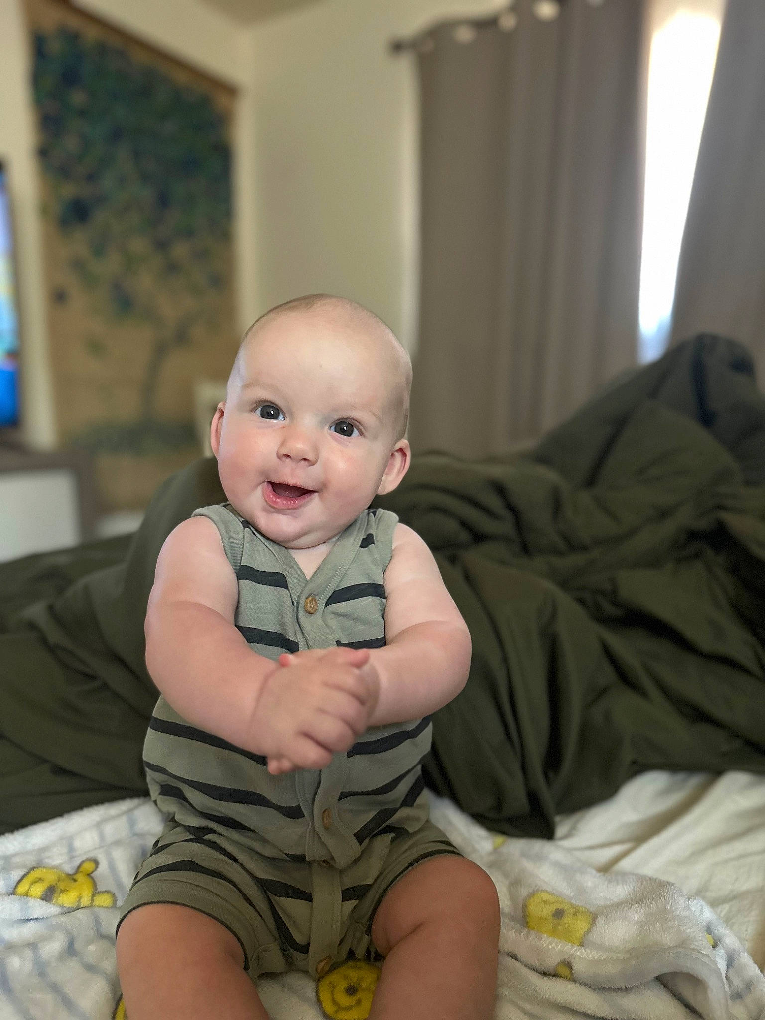 Ryker is registered to the contest to win money with this photo: baby, baby_toddler_clothing, cheek, child, comfort, curtain, face, foot, fun, happy, head, human_leg, leg, linens, person, picture_frame, sitting, skin, smile, thigh