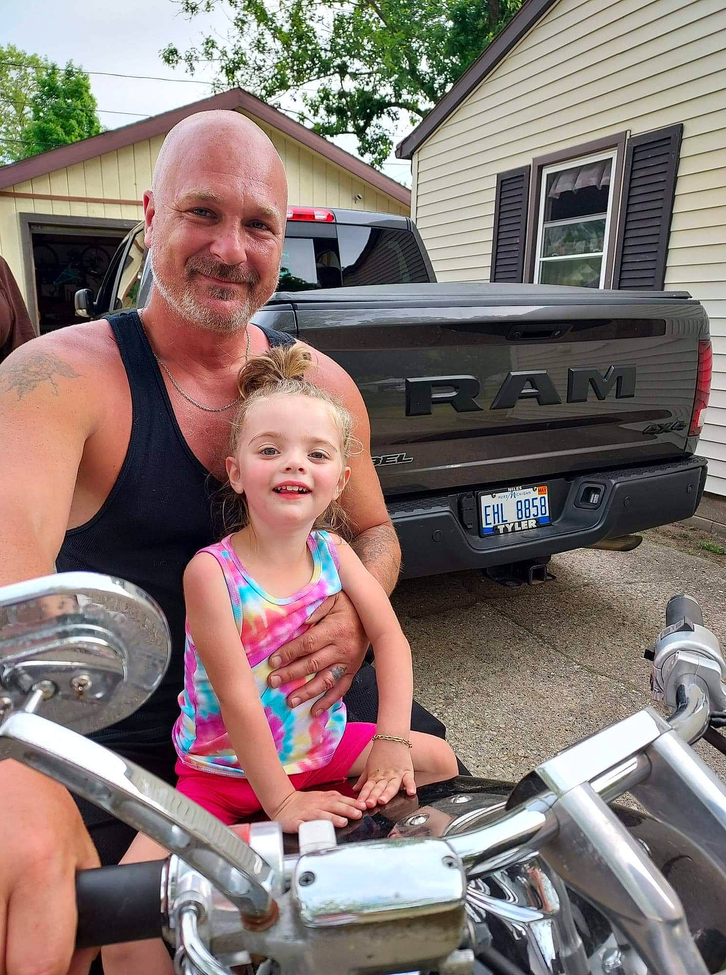Kaelyahna is registered to the contest to win money with this photo: automotive_design, automotive_exterior, automotive_lighting, automotive_tire, automotive_wheel_system, bumper, car, hood, house, joy, motor_vehicle, muscle, person, recreation, shorts, smile, tire, toddler, tree, vehicle