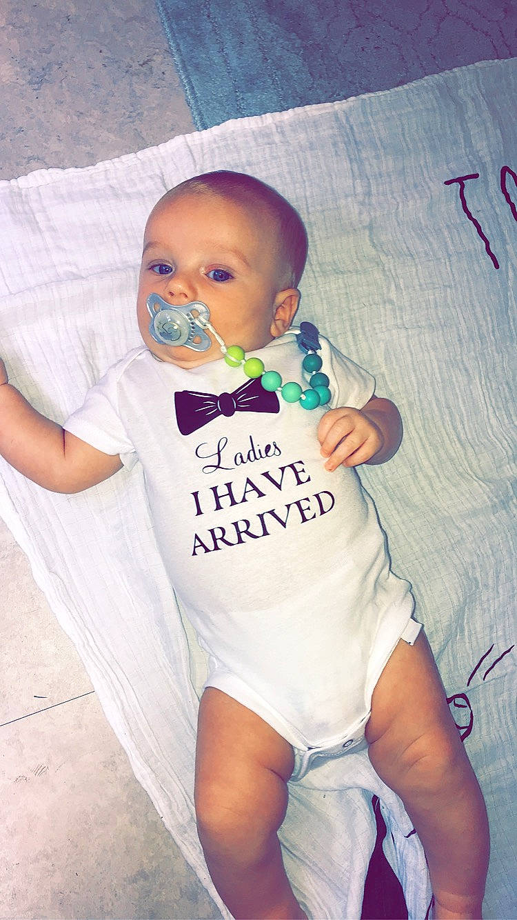 Zayden is registered to the contest to win money with this photo: arm, azure, baby, baby_toddler_clothing, cheek, chin, cool, eye, face, finger, hair, happy, head, mouth, neck, nose, person, skin, sleeve, textile