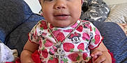 Adina is registered to the contest to win money with this photo: baby, child, girl, red_tutu, headband, strawberry_pattern, minnie_mouse, jewelry, necklace, indoor, couch, pillow, clothing, cute, portrait, smiling, person, sitting, infant, headwear