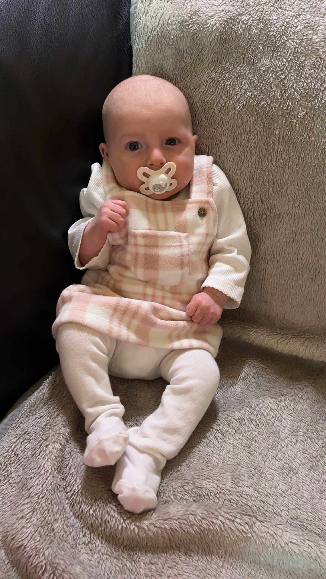 Marliya joined the competition — help win amazing prizes! baby, blanket, child, comfortable, couch, cozy, cute, expression, face, footed_pants, indoor, infant, pacifier, plaid, portrait, sitting, small_hands, soft_texture, white_clothing, young