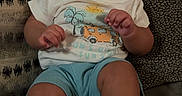 Jakobee joined the competition — help win amazing prizes! baby, child, couch, cute, expression, face, feet, hands, happy, indoor, infant, patterned_cushion, person, portrait, relaxed, shorts, sitting, smiling, tshirt, young