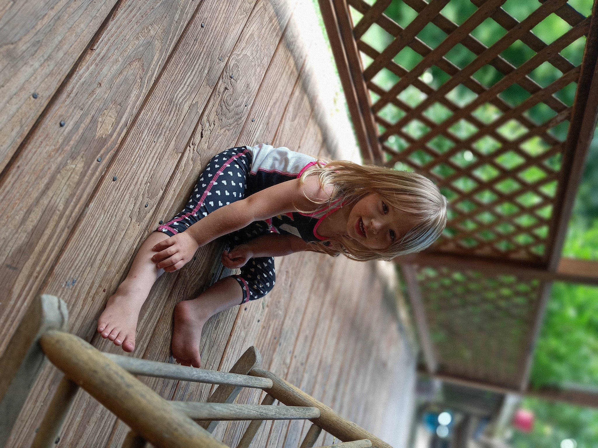 Aubrie is registered to the contest to win money with this photo: child, comfort, elbow, eyewear, flooring, foot, fun, grass, happy, hardwood, human_leg, leisure, pattern, person, sitting, sunglasses, thigh, vacation, waist, wood