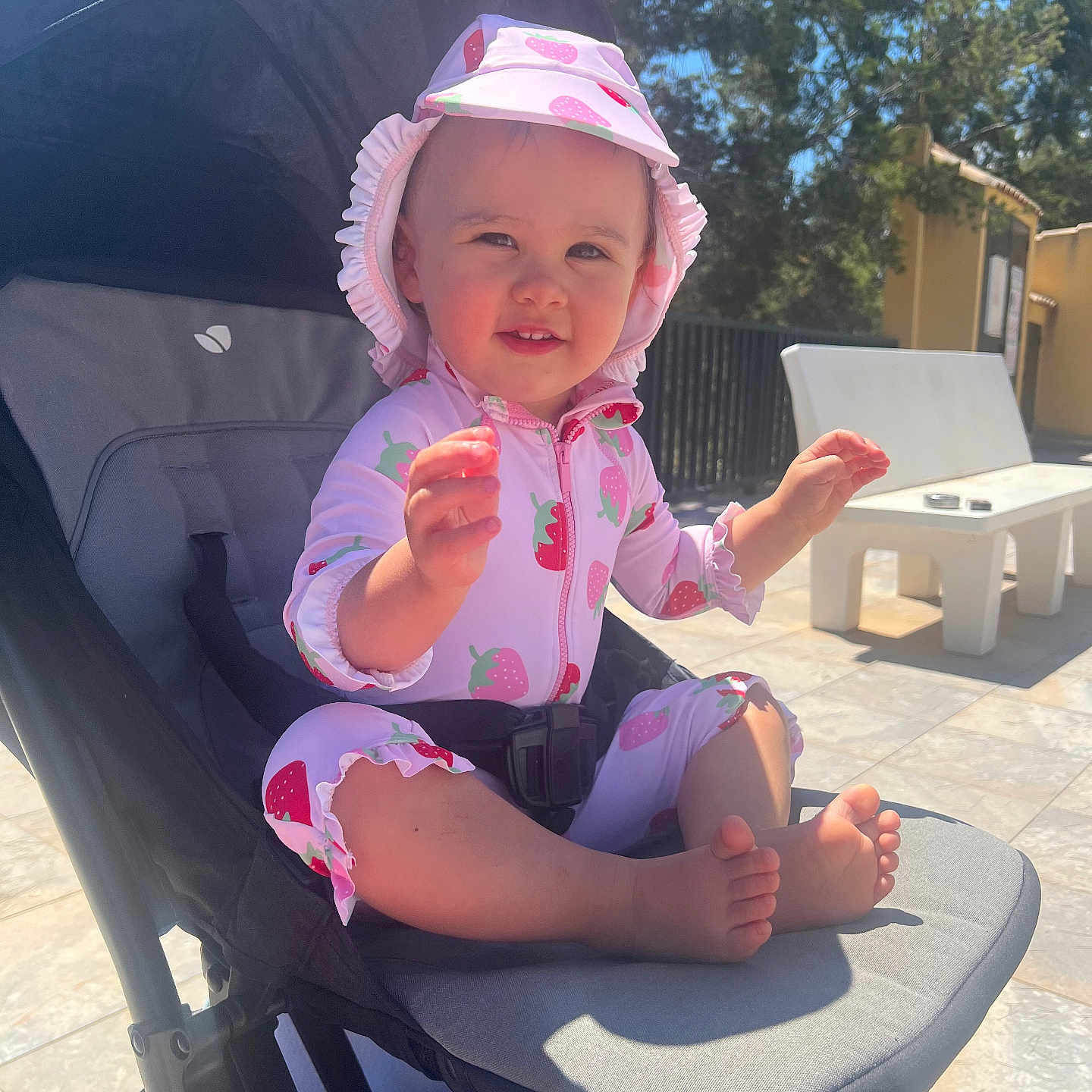 Aria joined the competition — help win amazing prizes! baby, baby_clothing, child, cute, daylight, foot, happy, hat, infant, nature, outdoor, person, playful, seat, smile, stroller, summer, sunhat, sunlight, toddler