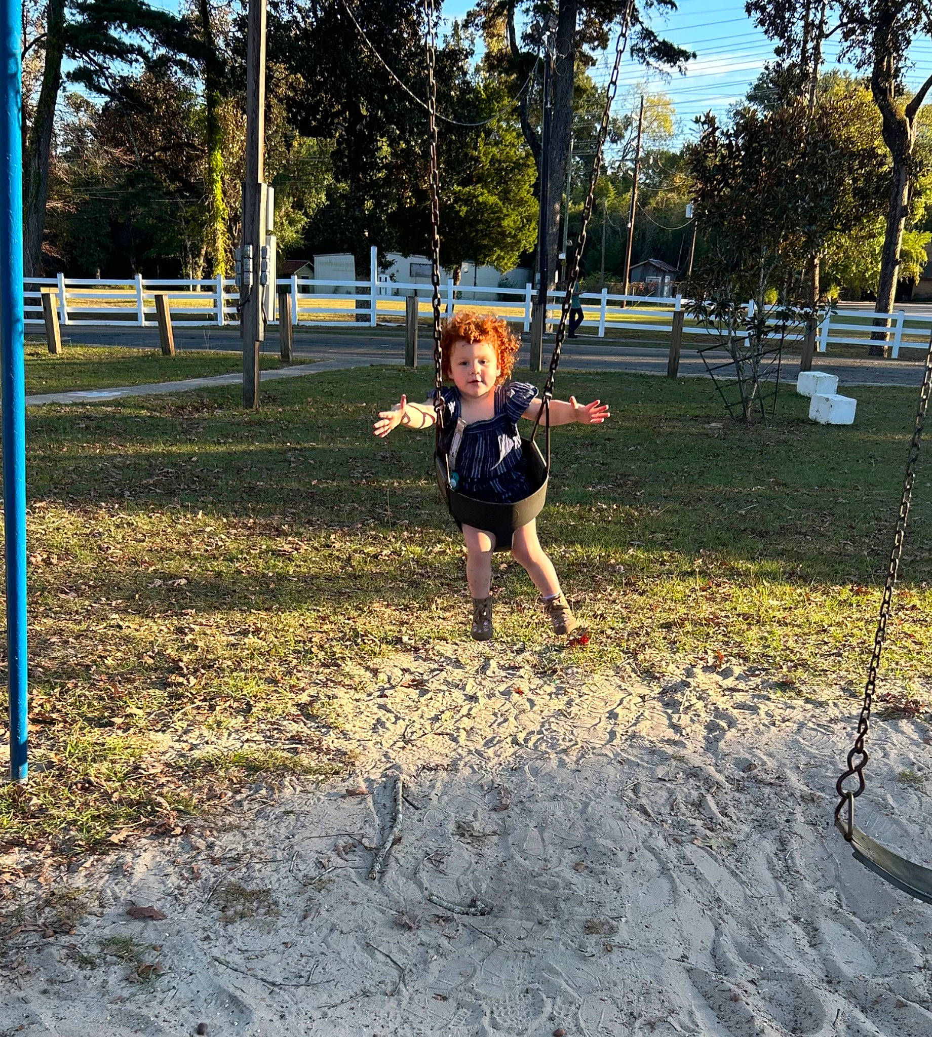 Adalyn joined the competition — help win amazing prizes! asphalt, city, fun, grass, happy, landscape, leisure, outdoor_play_equipment, people_in_nature, person, plant, playground, public_space, recreation, shade, sky, smile, swing, tints_and_shades, toddler