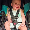 Ronnie joined the competition — help win amazing prizes! baby, child, car_seat, smiling, happy, infant, seatbelt, striped_clothing, rosy_cheeks, cute, sitting, person, young_child, indoor, safety, small_child, one_person, car_seat_harness, baby_clothes, cheerful