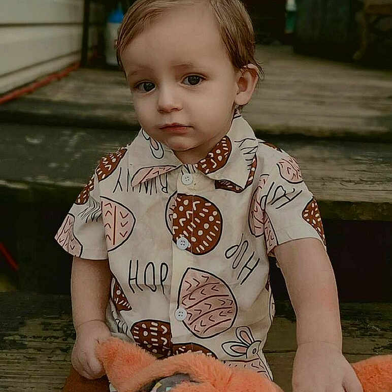 Nolan is registered to the contest to win money with this photo: baby, beachwear, brownhair, clothing, crawling, face, hair, head, person, photography, portrait, sitting, sleeve, t_shirt