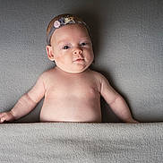 Mila joined the competition — help win amazing prizes! baby, bare_chest, blanket, child, cute, expression, gray_background, head, headband, indoors, infant, lying_down, peaceful, portrait, resting, skin, small_hands, soft_texture, toddler, young_child