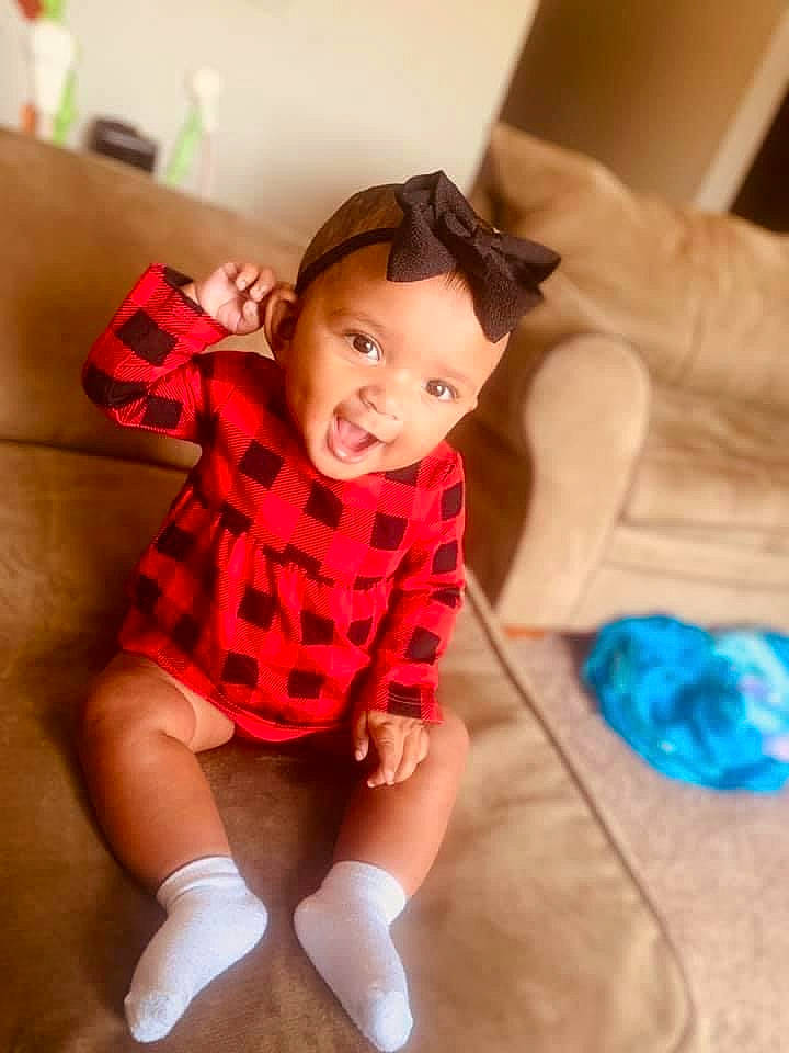 Kahlia joined the competition — help win amazing prizes! baby_toddler_clothing, dress, face, facial_expression, finger, happy, head, joint, knee, leg, neck, person, shoulder, skin, sleeve, smile, sock, tartan, textile, thigh