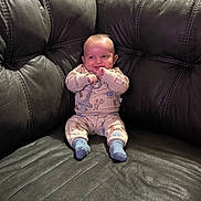 Eliseo joined the competition — help win amazing prizes! baby, infant, pajamas, leather_couch, smiling, sitting, indoors, child, cute, happy, person, furniture, home, cozy, sock, small_child, portrait, comfortable, playful, young