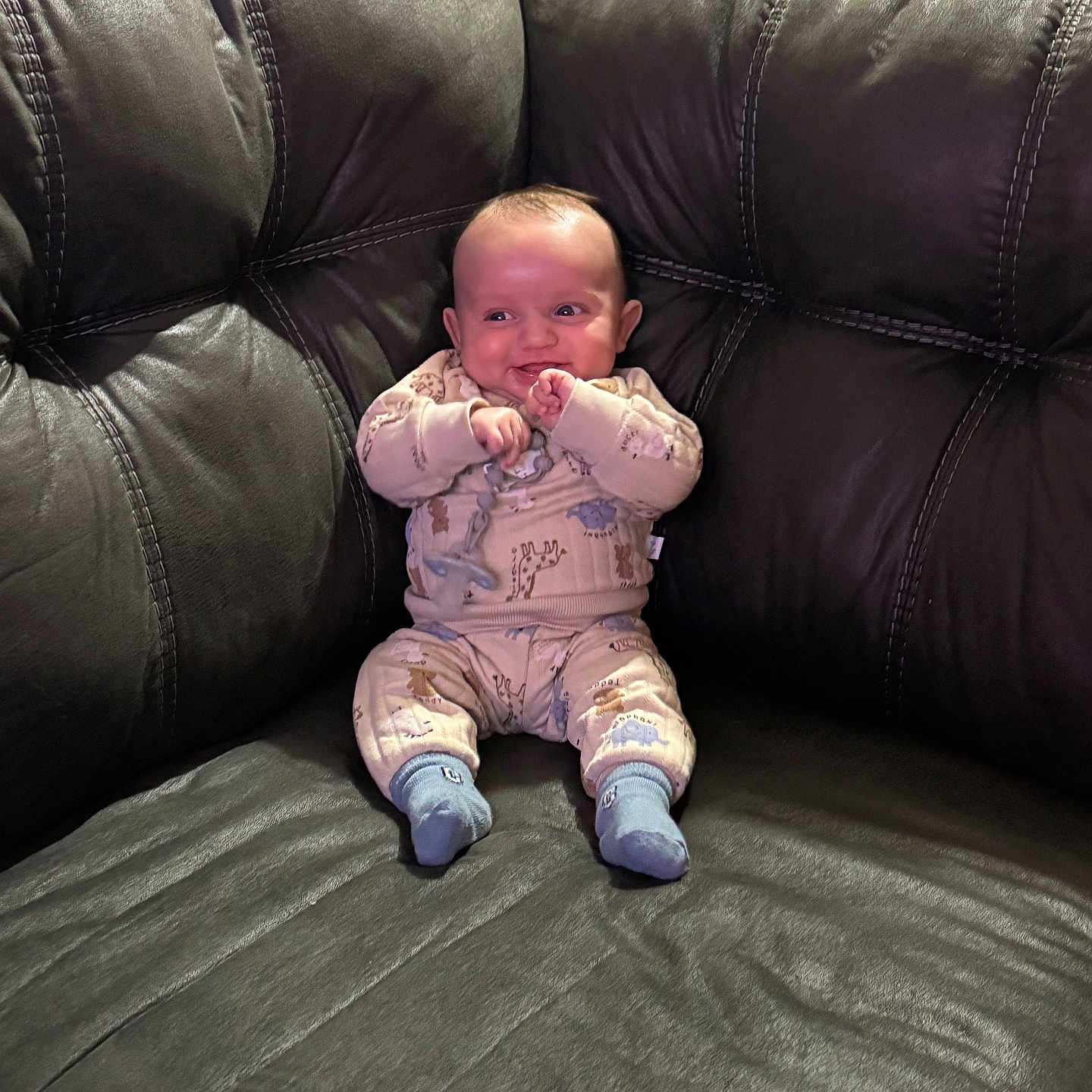 Eliseo joined the competition — help win amazing prizes! baby, child, comfortable, cozy, cute, furniture, happy, home, indoors, infant, leather_couch, pajamas, person, playful, portrait, sitting, small_child, smiling, sock, young