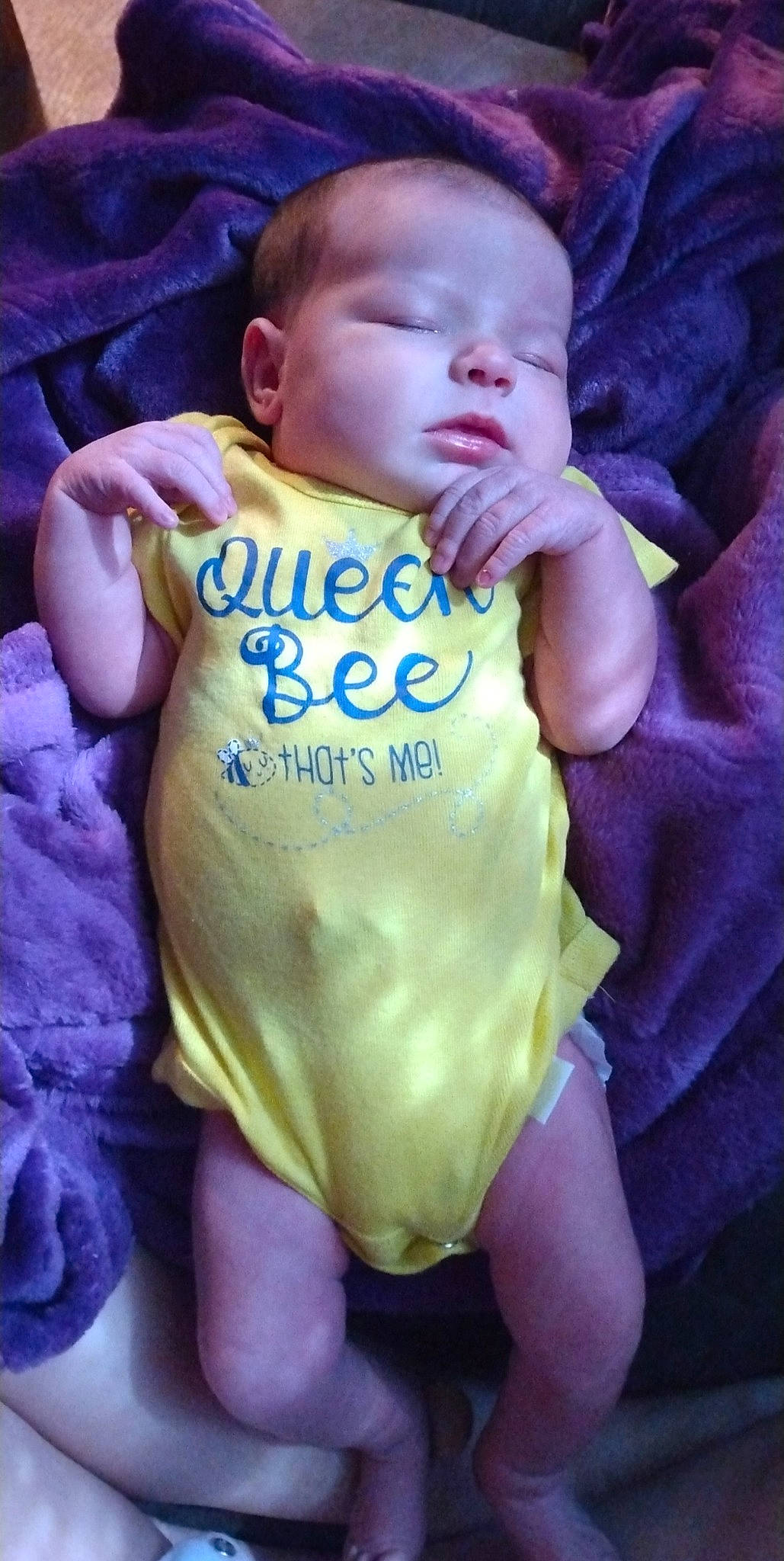 Lacey is registered to the contest to win money with this photo: baby, baby_toddler_clothing, cheek, chest, child, eye, finger, gesture, hand, happy, human_body, infant_bodysuit, iris, lip, nail, person, pink, skin, sleeve, thumb