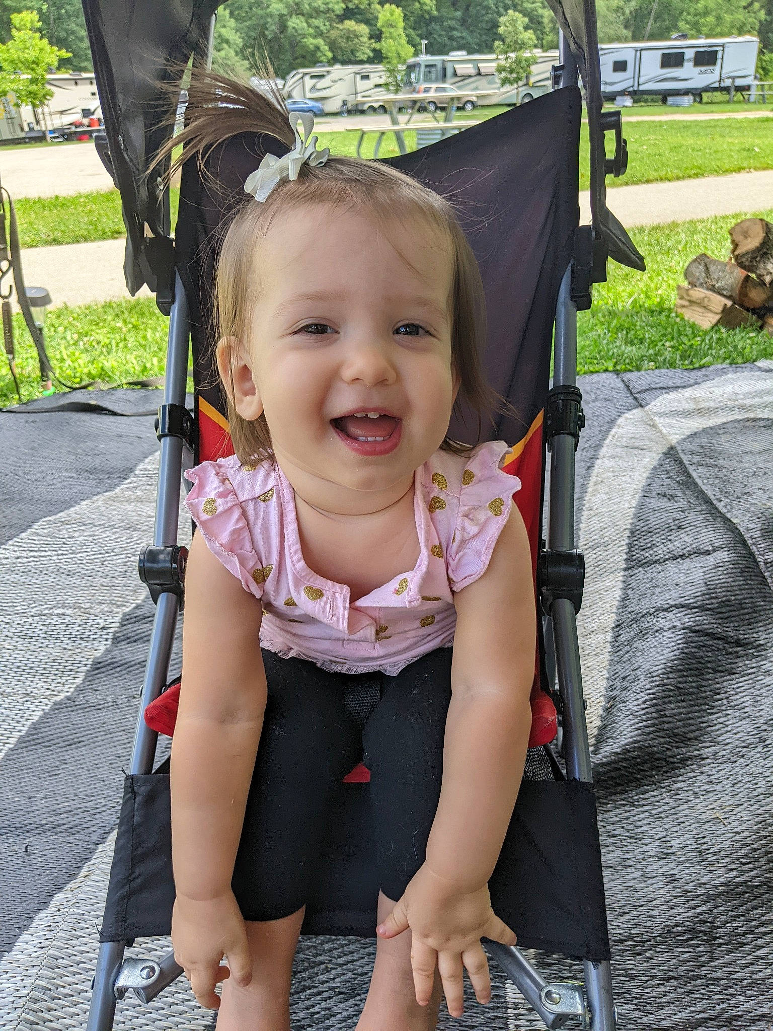 Kora is registered to the contest to win money with this photo: auto_part, baby, baby_carriage, baby_products, baby_toddler_clothing, chair, child, event, fun, grass, happy, leisure, person, plant, recreation, sitting, skin, smile, strap, toddler