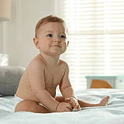 Liam is registered to the contest to win money with this photo: baby, bed, blanket, child, childhood, cozy, cute, furniture, happy, home, indoors, infant, light, natural_light, portrait, room, sitting, skin, smile, window