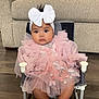 baby, child, pink_dress, white_bow, headband, chair, butterfly_embroidery, cute, indoors, couch, floor, plush, seated, infant, adorable, portrait, legs, feet, home, comfortable