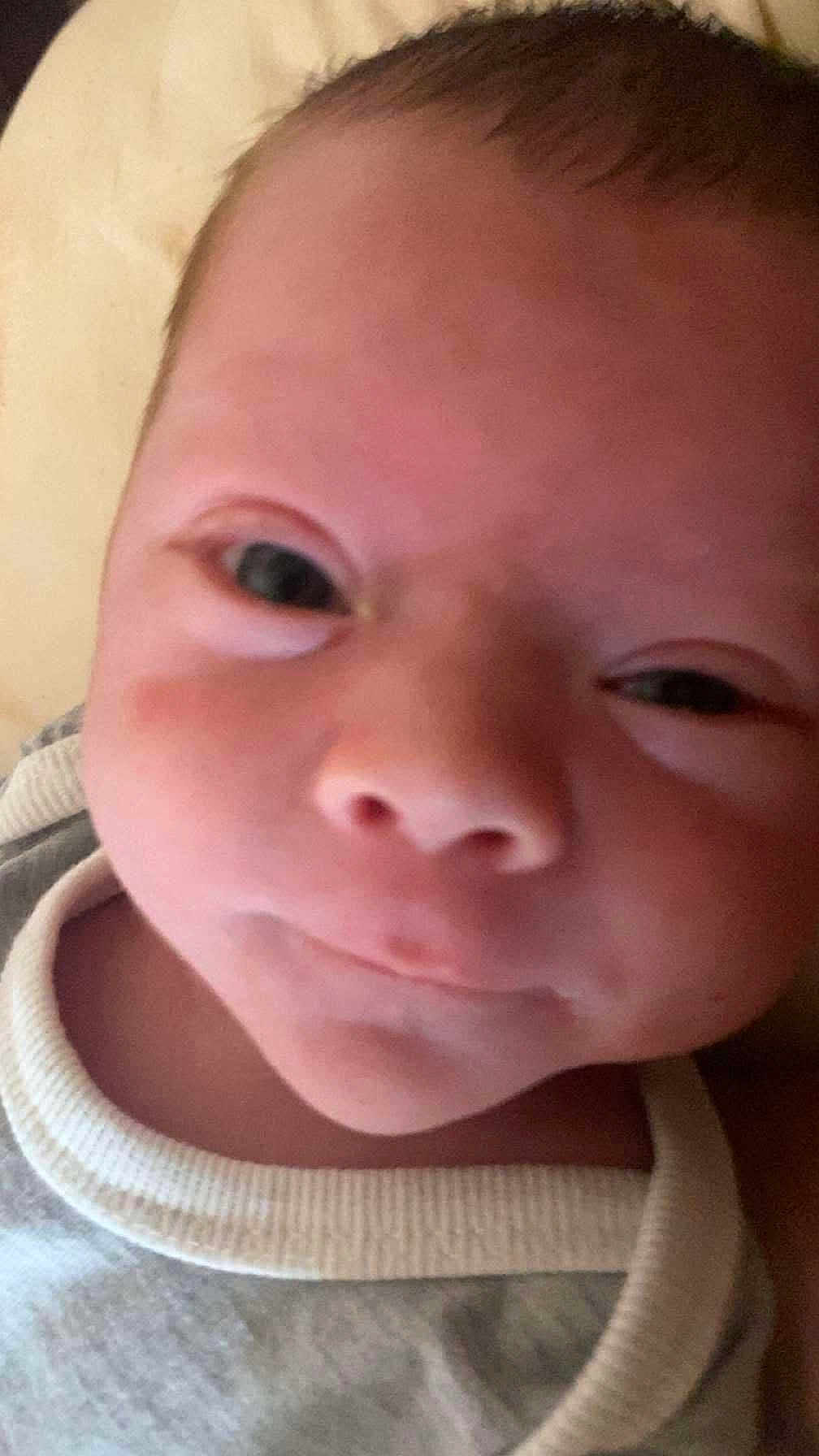 Christopher joined the competition — help win amazing prizes! baby, newborn, infant, face, closeup, portrait, eyes, nose, mouth, cheeks, expression, onesie, clothing, skin, forehead, head, bedding, soft_light, sleepy, adorable