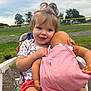 toddler, child, baby_doll, outdoor, grass, trees, cloudy_sky, chair, smiling, playing, pink_clothing, shorts, happy, portrait, person, nature, daylight, toy, cute, young_child