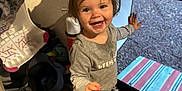 Avery joined the competition — help win amazing prizes! toddler, child, indoor, smiling, purple_bow, gray_outfit, shoes, door, mat, happy, standing, young_child, person, footwear, carpet, floor, toy, clothing, hair_bow, expression