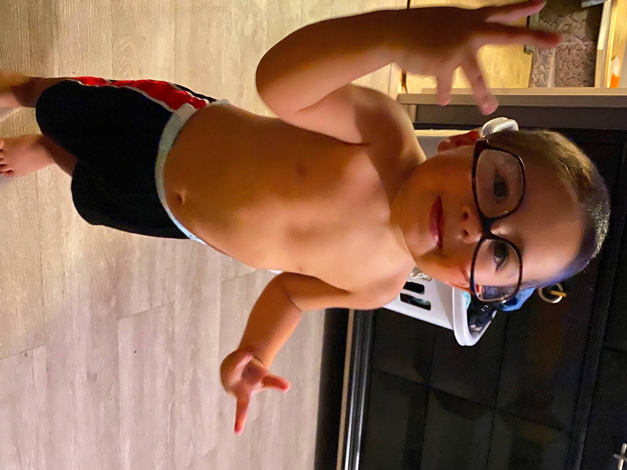 Moses is registered to the contest to win money with this photo: black_hair, chest, elbow, eyewear, glasses, human_leg, joint, joy, knee, muscle, navel, person, shoulder, smile, stomach, swimwear, thigh, trunk, undergarment, underpants