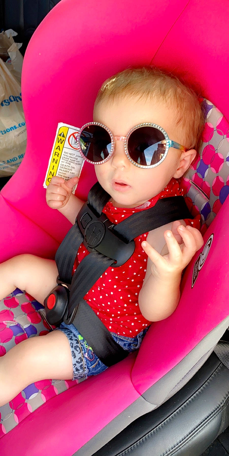 Gracie joined the competition — help win amazing prizes! car_seat, child, cool, design, doll, eyewear, glasses, magenta, pattern, person, personal_protective_equipment, pink, plaid, sunglasses, thigh, toddler, toy, vision_care