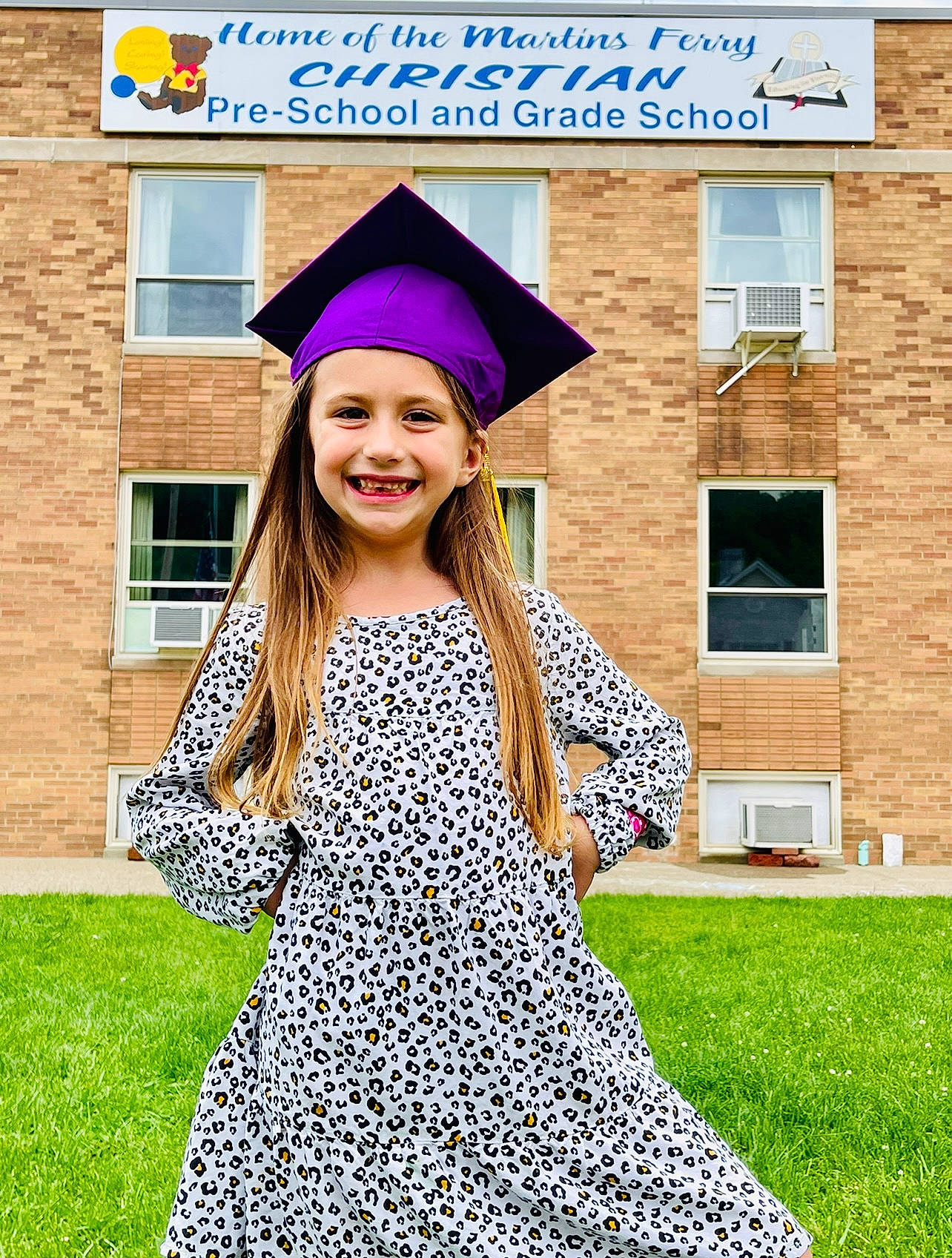 Annalynn is registered to the contest to win money with this photo: academic_dress, beauty, blue, clothing, facial_expression, fashion, fun, graduation, grass, happy, headgear, headwear, joy, mortarboard, one_piece_garment, outerwear, people_in_nature, person, public_space, scholar
