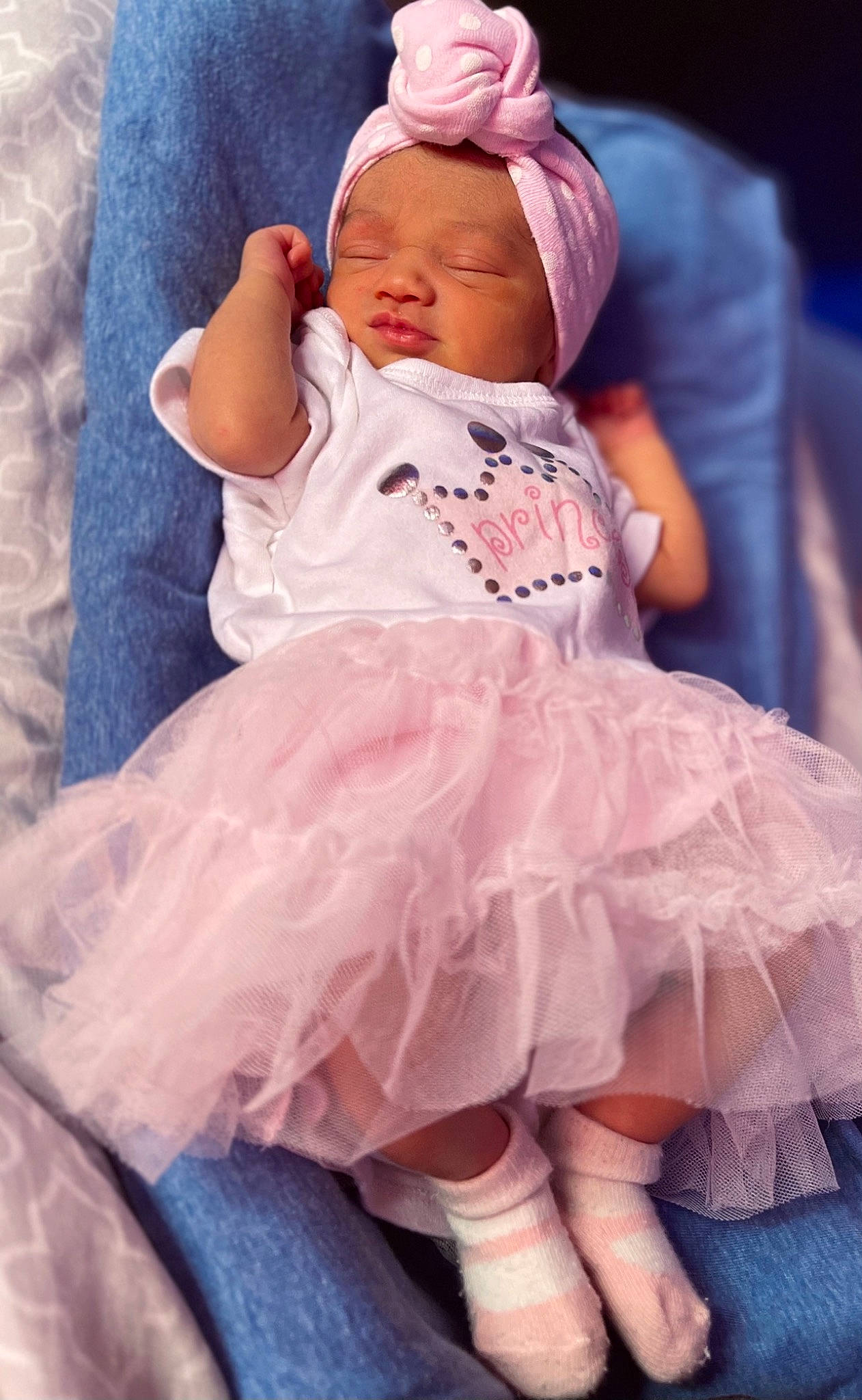 Alessandra is registered to the contest to win money with this photo: arm, baby, baby_products, baby_sleeping, baby_toddler_clothing, comfort, embellishment, face, happy, headwear, human_body, iris, linens, magenta, person, pink, purple, skin, sleeve, textile