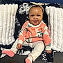 Milani joined the competition — help win amazing prizes! baby, child, smiling, sitting, couch, pillow, blanket, headband, clothing, pink_socks, indoor, portrait, cute, happy, face, apparel, infant, cozy, furniture, home
