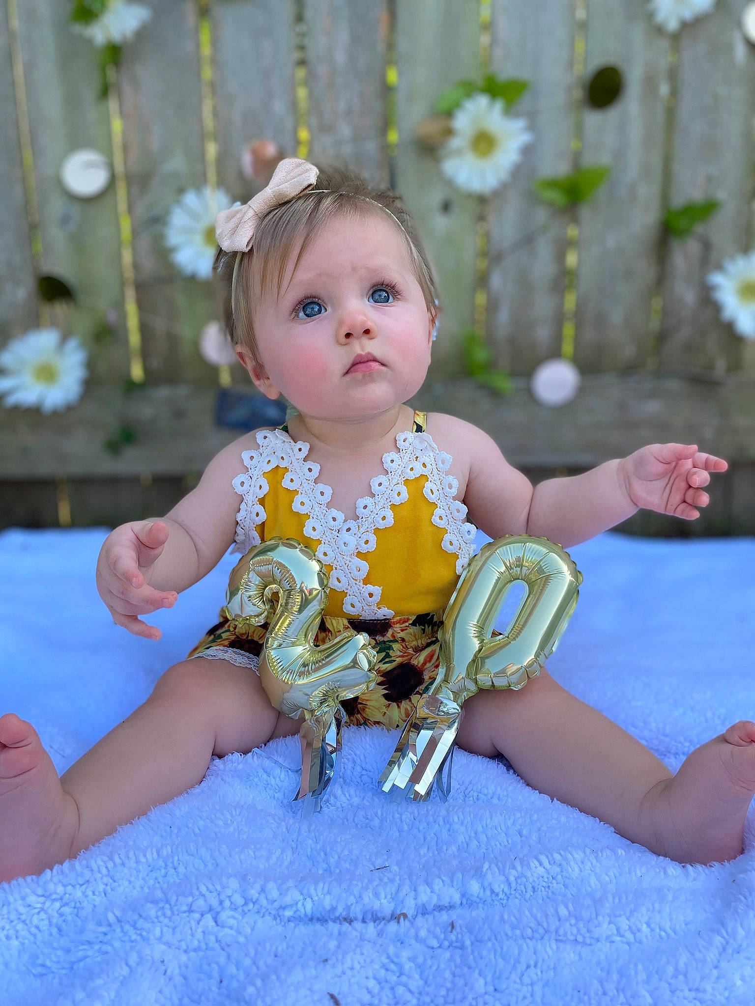 Sloane is registered to the contest to win money with this photo: baby, baby_toddler_clothing, child, costume, dress, fashion_accessory, fawn, fun, hair_accessory, headpiece, person, sitting, smile, surprise, toddler, yellow