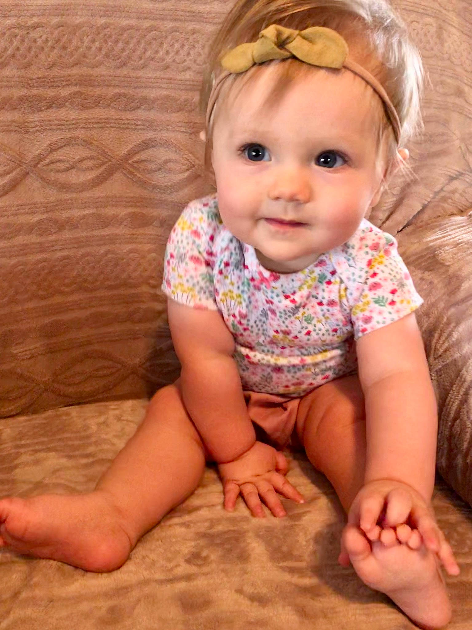 Sloane is registered to the contest to win money with this photo: baby, baby_toddler_clothing, barefoot, blond, cheek, child, child_model, finger, foot, hair_accessory, hand, head, headband, headgear, joy, leg, person, sitting, skin, toddler