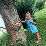Aliya a rejoint le concours — aidez-le/la à gagner de superbes lots ! child, girl, blue_dress, tree, grass, greenery, outdoor, nature, plant, bush, summer, playful, curious, person, young, standing, footwear, sandals, leaf, trunk